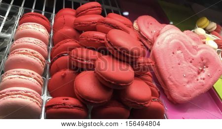Valentine's Day Sweets a colorful tray of red and pink specialty dessert macaroons with heart shape for decadent Valentine gift