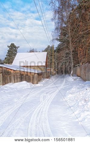 road in winter village covered with snow
