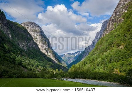Scenic norwegian landscape with steep mountains and canyon with mountain river. Norway fairytale.