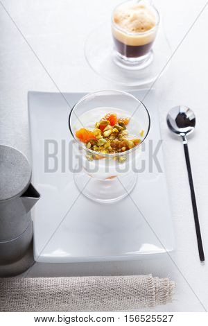 Homemade yogurt with dried apricots and coffee.
