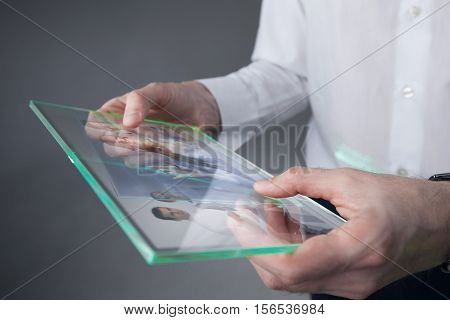 Futuristic tablet with a transparent display in human hands Concept actual future innovative ideas