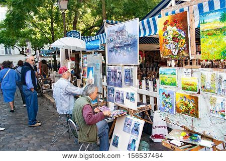 PARIS FRANCE, circa April 2016. Place du tertre in Montmartre. Close to the cathedral of the sacre coeur. The square du tertre is a meeting place of artists very visited by the tourists to take portraits in the moment