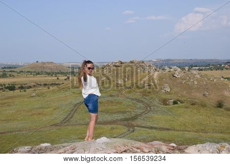 Girl on a mountain on the background of the steppe. Nature Monument -Kamyshinskye Mountain Ears. Volgograd region Russia
