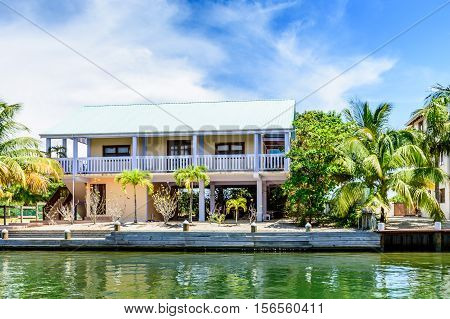 Placencia, Belize - August 28 2016: Tropical waterside house on lagoon side of Placencia in Belize, Central America