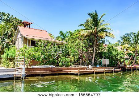 Placencia, Belize - August 28 2016: Tropical waterside house on lagoon side of Placencia in Belize, Central America