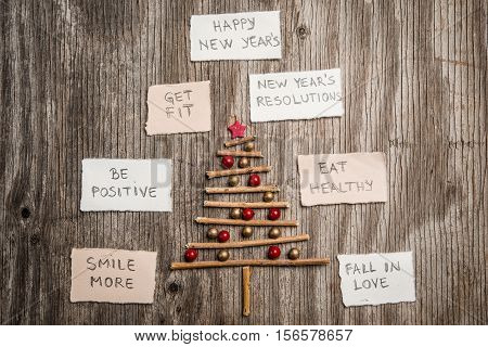 Christmas Tree And New Year Resolutions On Rustic Wooden Background
