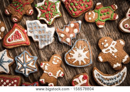 Colorfully Christmas Cookies On Rustic Wooden Background, Gingerman And Tree