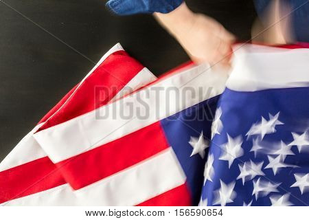 Large American Flag on the dark table.