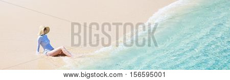 panorama of young woman in sunhat and rashguard or swimsuit enjoying perfect caribbean beach sun protection concept