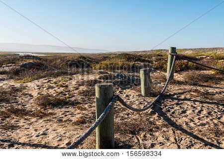 Sand dunes and rope border at the Tijuana River National Estuarine Research Reserve in San Diego, California.