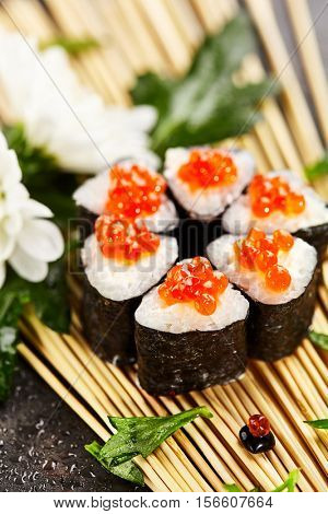 Ikura Maki Sushi - Roll with Cream Cheese inside. Topped with Ikura (Salmon Roe)