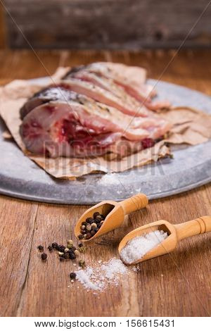 some pieces of fresh raw fish with salt and pepper