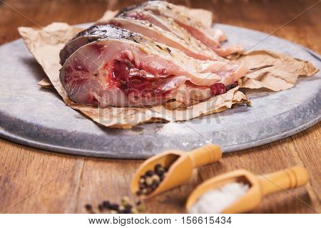 some pieces of fresh raw fish with salt and pepper