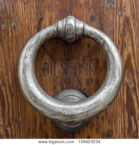 Decorative vintage door handle on a wooden door