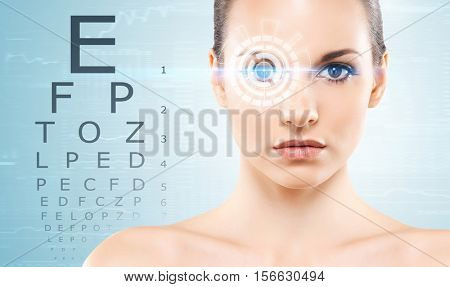 Beautiful woman with laser hologram and test vision table over cyan background.