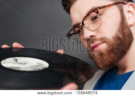 Close up man with vynil. cropped image. hipster. isolated black background