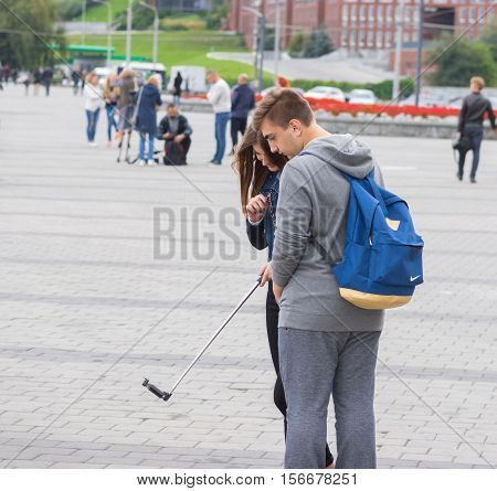 DNEPR UKRAINE - SEPTEMBER 24 2016:Loving couple of teenagers making selfie on a Dnepr river embankment in Dnepr city, Ukraine at September 24,2016