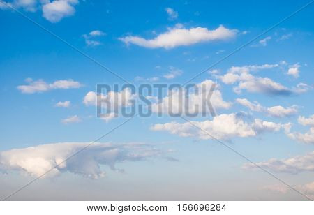 Clouds in the blue sky with atmospheric haze