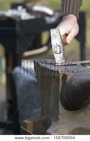 Black smith hitting hot steel on an anvil