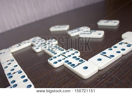 Dominoes on wooden table background. Entertainment. A game