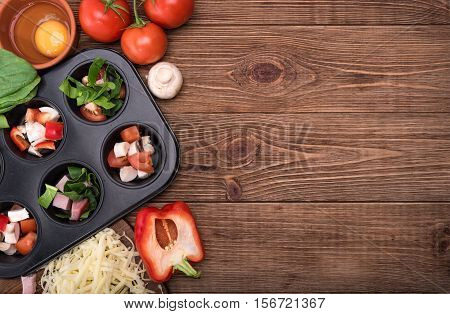 Delicious egg muffins with ham, cheese and vegetables. Concept of cooking.