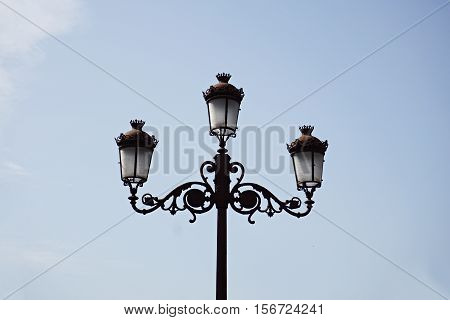 Typical Spanish decorated street lamp and lantern as a symbol of antiquated Spanish design and architecture