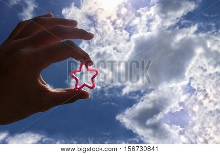 Hold shining star against the sunlight.Reach to be your owner success