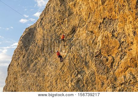 Two climbers on a steep rock. Cape Alchak Crimea.