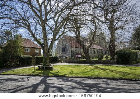 Saint George church and green int he village of Brede Kent UK