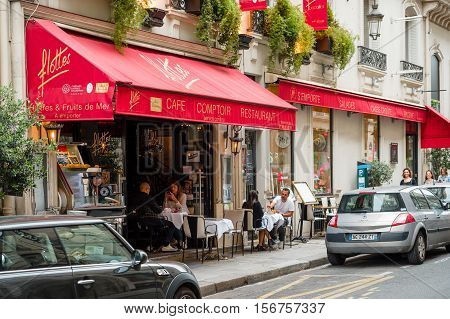 PARIS FRANCE - MAY 21 2016: Cafe brasserie restaurant Flottes in central Paris on 2 rue Cambon with people eating and having fun on the oudside tables