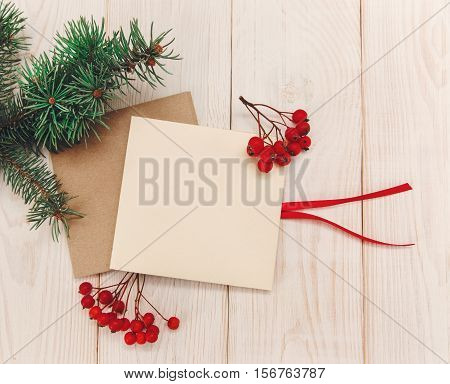 Christmas mokup.Tree branch frame empty cards with rowanberry .White wooden table.Top view