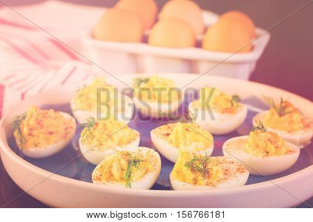 Deviled eggs garnished with fresh dill on the plate