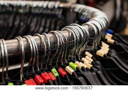 Many hangers on a rack in the store.