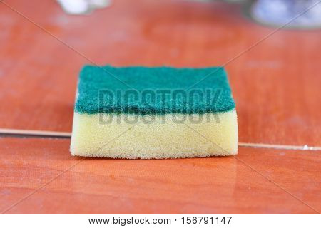 sponge wash dishes household for cleaning (Scotch-Brite selective focus front with shallow depth of field )