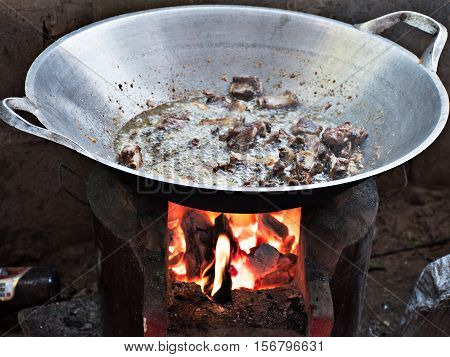 Cooking by a hot flame from charcoal.