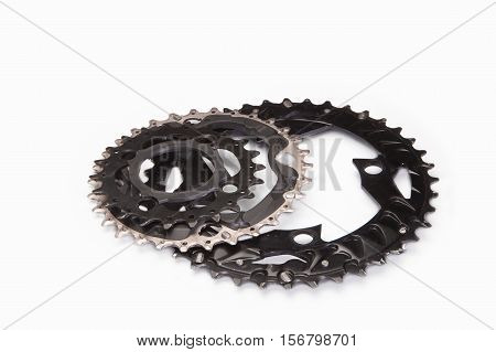 Three bicycle chainwheels and chainring on a white background