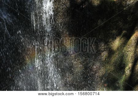 Rainbow at the waterfall Millomeris in the mountains in Cyprus