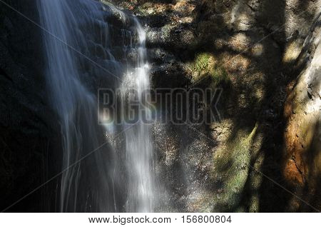 Rainbow at the waterfall Millomeris in the mountains in Cyprus