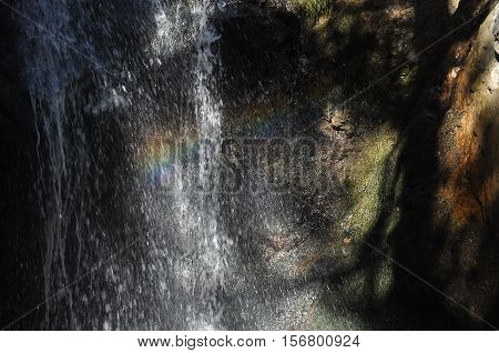 Rainbow at the waterfall Millomeris in the mountains in Cyprus