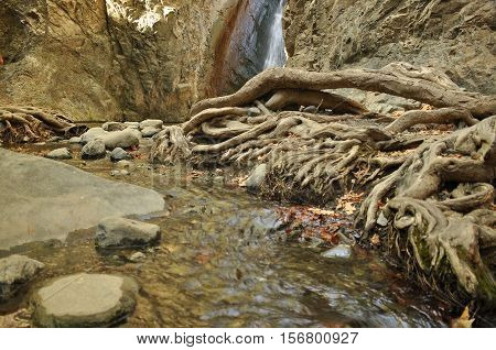 Rainbow at the waterfall Millomeris in the mountains in Cyprus