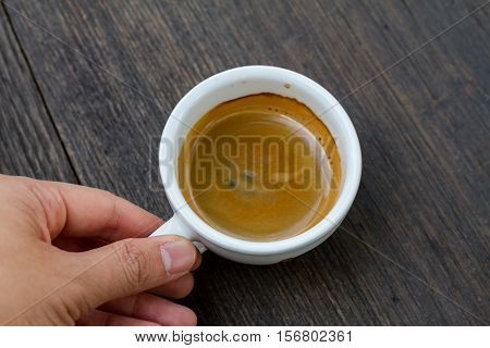 Espresso double shot on wood background vintage tone shallow depth of field
