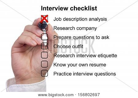 Hand crosses off the first item on a preparation checklist to prepare for job interview