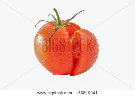 Tomato and a slice of tomato on white background isolated