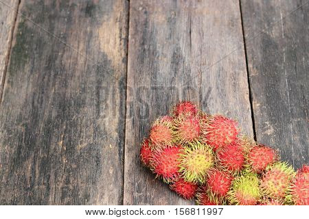 rambutan sweet fruit fresh on wood background :Select focus with shallow depth of field.