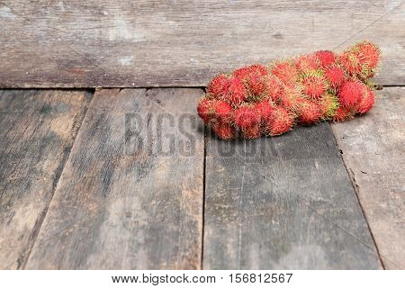 rambutan sweet fruit fresh on wood background :Select focus with shallow depth of field.