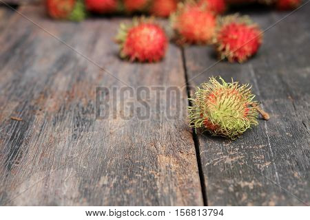 rambutan sweet fruit fresh on wood background :Select focus with shallow depth of field.