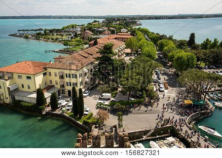 SIRMIONE ITALY - MAY 5 2016: View of colorful old buildings in Sirmione and Lake Garda from Scaliger castle wall Italy