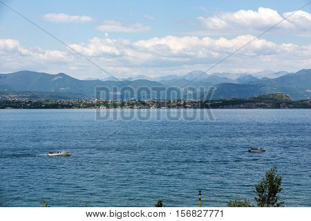 Landscape of the coast of Sirmione peninsula which divides the lower part of Lake Garda. It is a famous vacation place for a long time in northern Italy.
