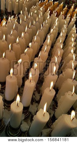 White candles lit up as an offering worhip