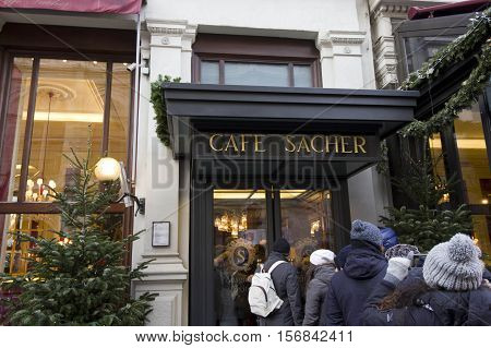 VIENNA, AUSTRIA - DECEMBER 31 2015: Entrance of Cafe Sacher Hotel in Vienna with people in queue